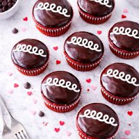 These bakery-style red velvet cupcakes are filled with sweet vanilla cream and finished with a chocolate ganache topping. A fun, nostalgic dessert recipe everyone will love.