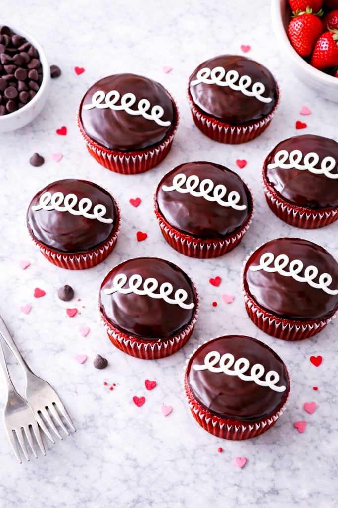 These bakery-style red velvet cupcakes are filled with sweet vanilla cream and finished with a chocolate ganache topping. A fun, nostalgic dessert recipe everyone will love.