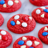 Make these delicious red velvet patriotic cookies with cake mix and colorful M&Ms! A fast and festive Fourth of July dessert that everyone will love.