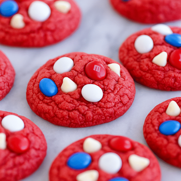 Make these delicious red velvet patriotic cookies with cake mix and colorful M&Ms! A fast and festive Fourth of July dessert that everyone will love.