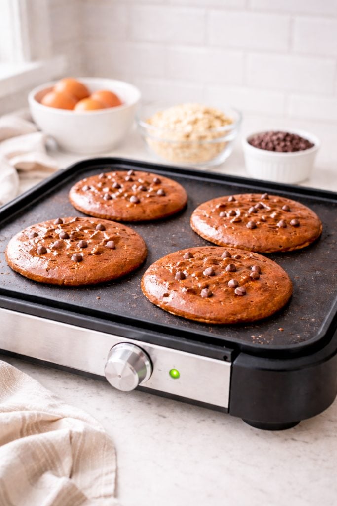 These healthy chocolate protein pancakes taste indulgent but are packed with protein. Made with Greek yogurt, eggs, oats, and cocoa powder for a satisfying breakfast that keeps you full.