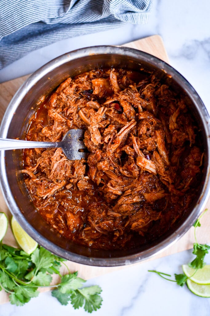 Slow cooked to perfection, this sweet pork recipe tastes just like Cafe Rio! Great for burritos, salads, and more.