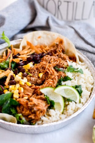 Make the famous Café Rio sweet pork salad at home—tender pork, cilantro-lime rice, beans, tomatillo-ranch, and all the crunchy toppings.