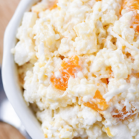 This classic Frog Eye Salad is creamy, fruity, sweet, and perfect for holidays, potlucks, and family dinners. Made with acini de pepe pasta, pineapple, mandarin oranges, marshmallows, and whipped topping!