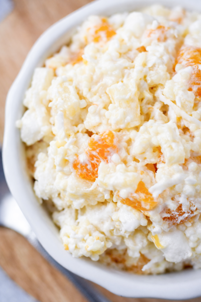 This classic Frog Eye Salad is creamy, fruity, sweet, and perfect for holidays, potlucks, and family dinners. Made with acini de pepe pasta, pineapple, mandarin oranges, marshmallows, and whipped topping!